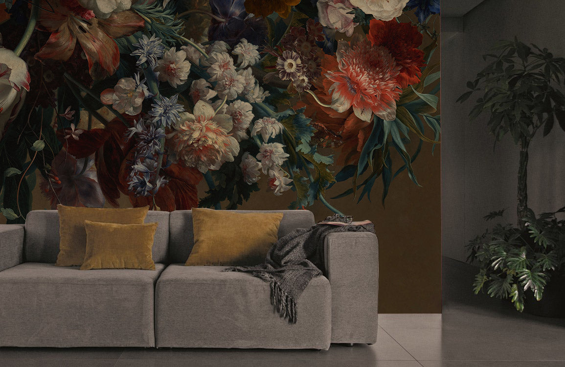 Elegant floral mural wallpaper with autumnal colours behind grey sofa in stylish living room setting.