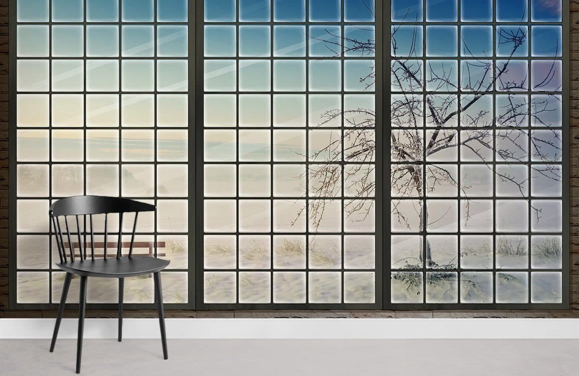 Winter Serenity Frosted Window Mural Wallpaper showcasing blue-white landscape with black chair, light wood flooring.